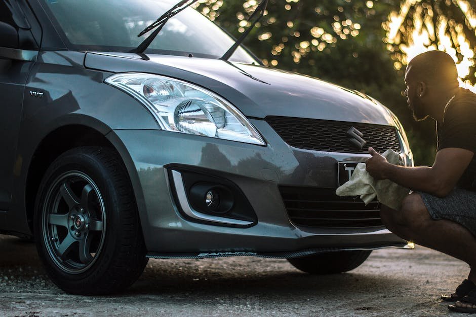 image 2 A person cleaning a car's exterior with a microfiber towel