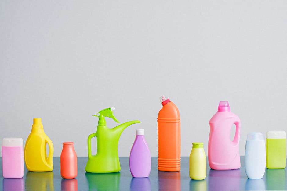 Image of various car wash materials, including soap, cloth, wheel cleaner, wax, and a vacuum, neatly arranged on a table.